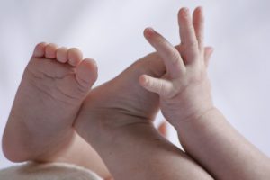 coseup of a baby's hand discovering his feet